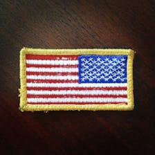 An American Flag patch with a gold border