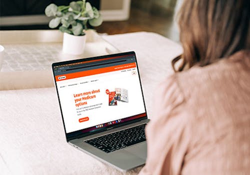 Woman looking at Devoted.com on her laptop.