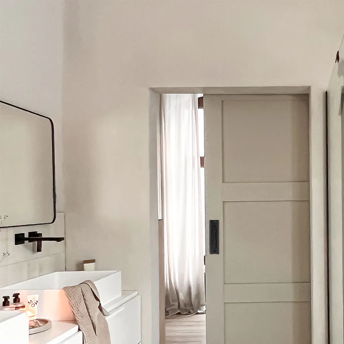 Bathroom in gray and beige tones with black accessories