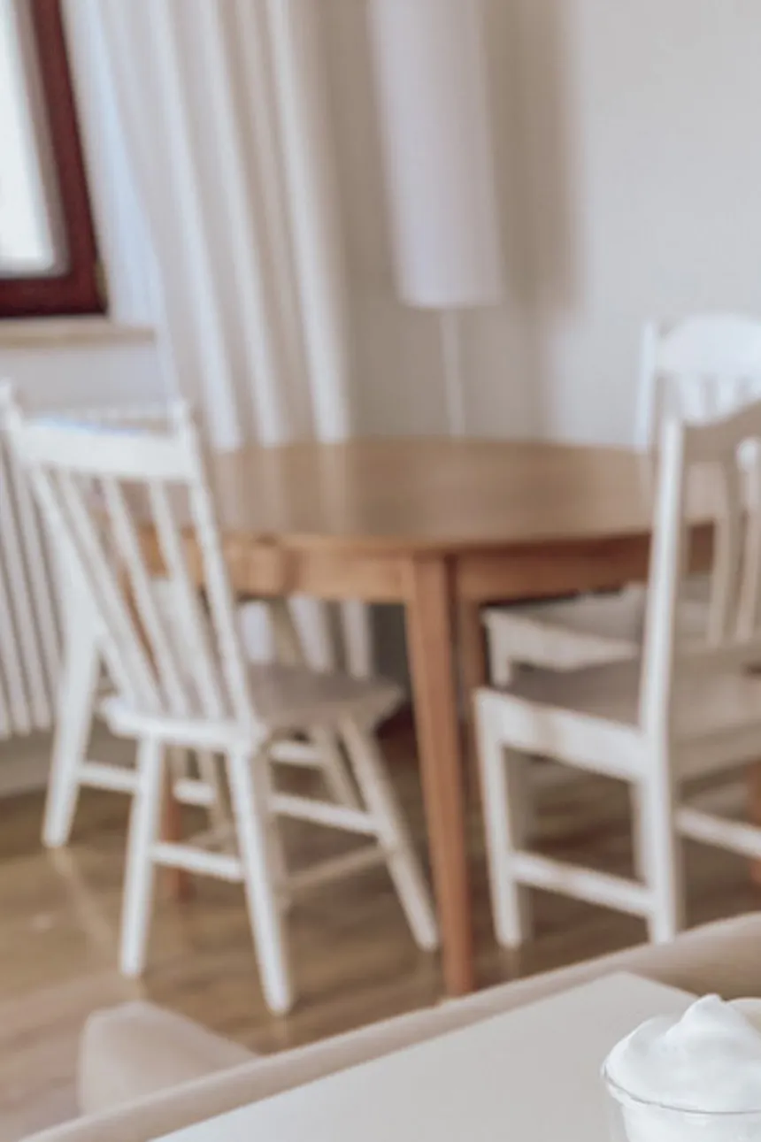 white large kitchen island, round table with white chairs, open plan kitchen with dining area