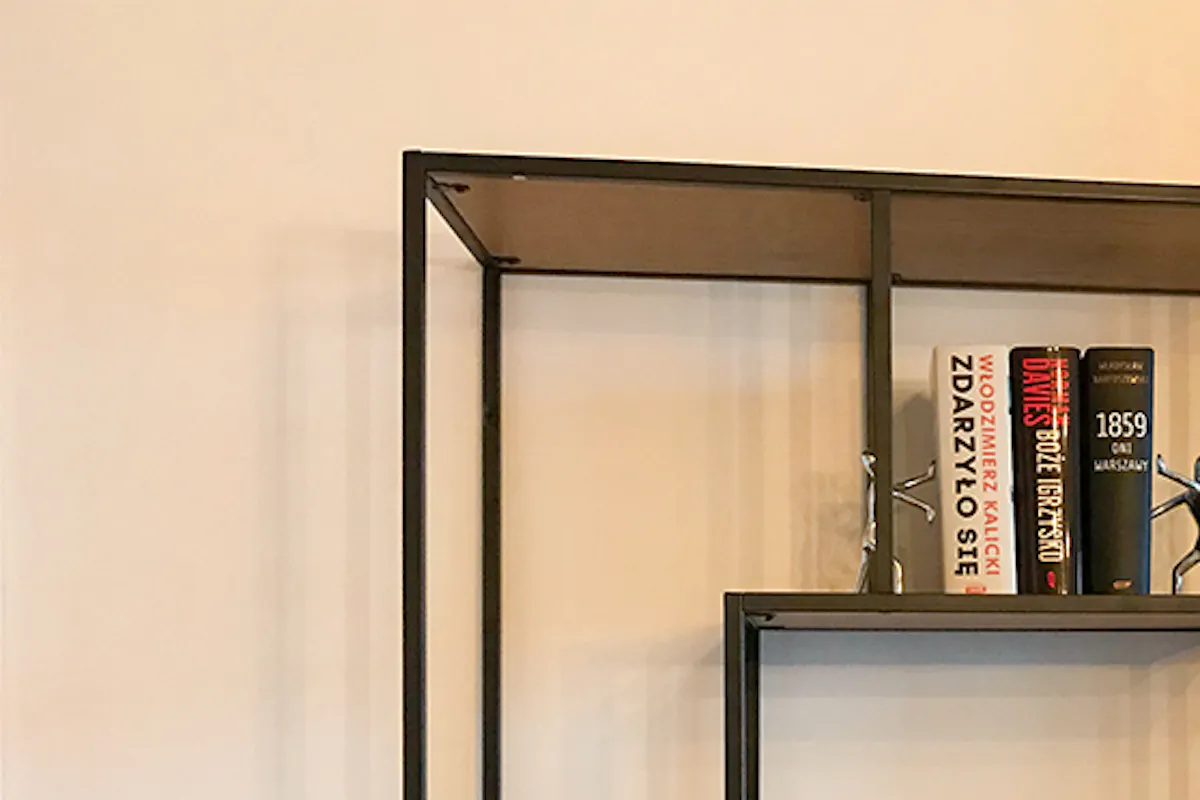 Interior with versatile style, industrial bookshelf, pictures on wall
