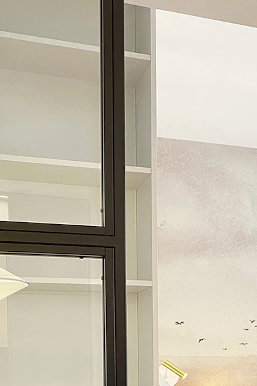 Double metal glass sliding door at bedroom entrance, modern apartment, linear stucco, bed with upholstered headboard
