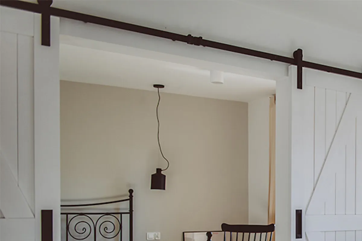 modern retro style, apartments for rent, double sliding doors, white sliding doors, barn door, open space, double door for bedroom, retro bedroom, rocking chair in bedroom