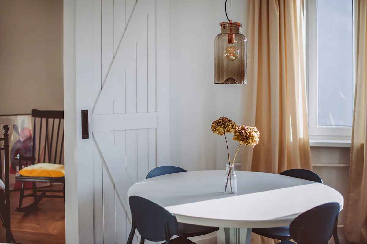 modern retro style, apartments for rent, double sliding doors, white sliding doors, barn door, open space, double door to bedroom, retro bedroom, rustic pendant lamp, metal bed