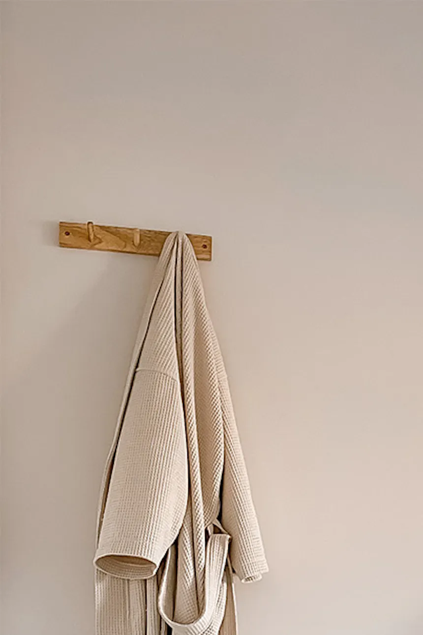 un cintre et une table en bois avec une lampe de chevet