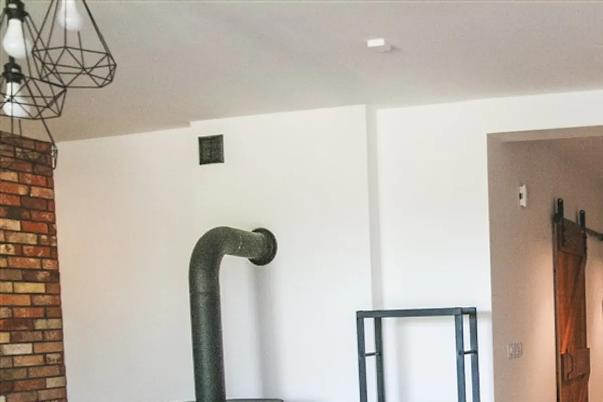 solid wood sliding door, Scandinavian interior, loft interior, kitchen door, barn door, brushed sliding door, kitchen sliding door, brick wall in living room, fireplace in living room, Scandinavian style in living room, open space, dining area in living room
