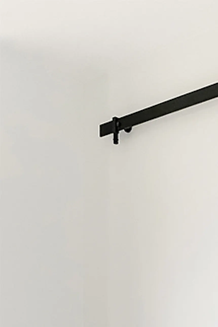 Mirror door in entryway, black minimalist table, industrial pendant lamp, mirror in wooden frame, glass vase on floor