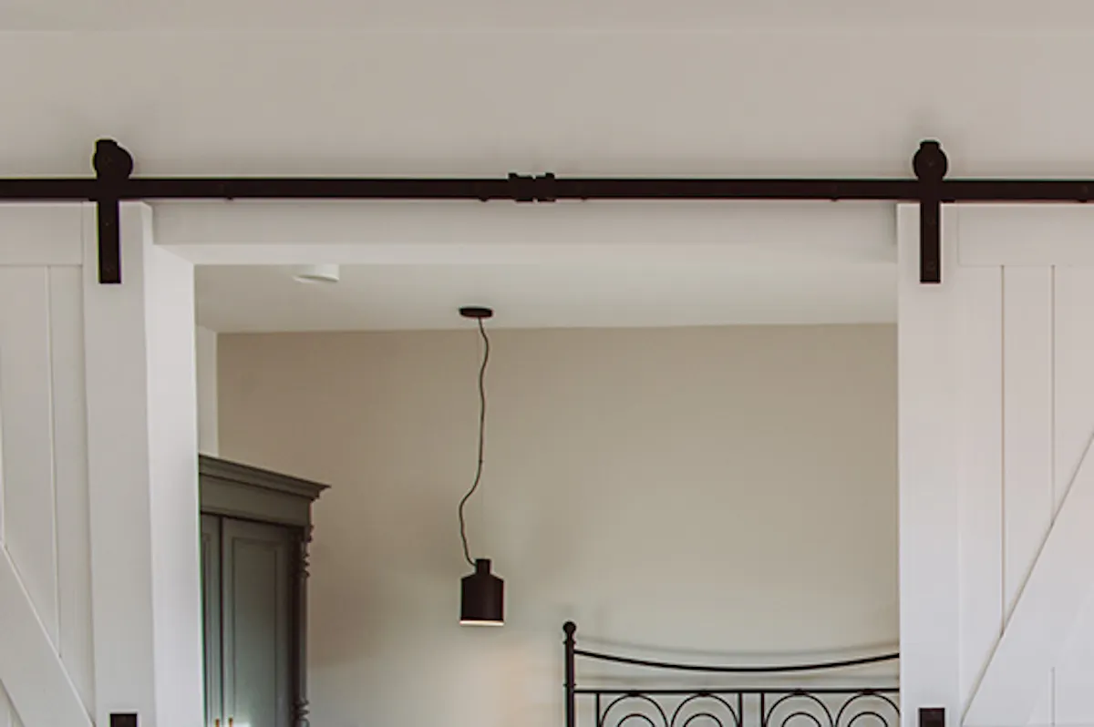 modern retro style, apartments for rent, double sliding doors, white sliding doors, barn door, open space, double door to bedroom, retro bedroom, rustic pendant lamp, metal bed