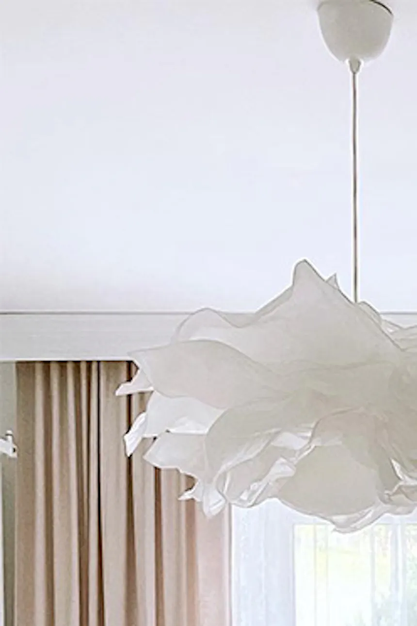white pouf and grey sofa in dressing room, large bright dressing room, white hanging lamp, bright walk-in closet, pendant paper lampshade