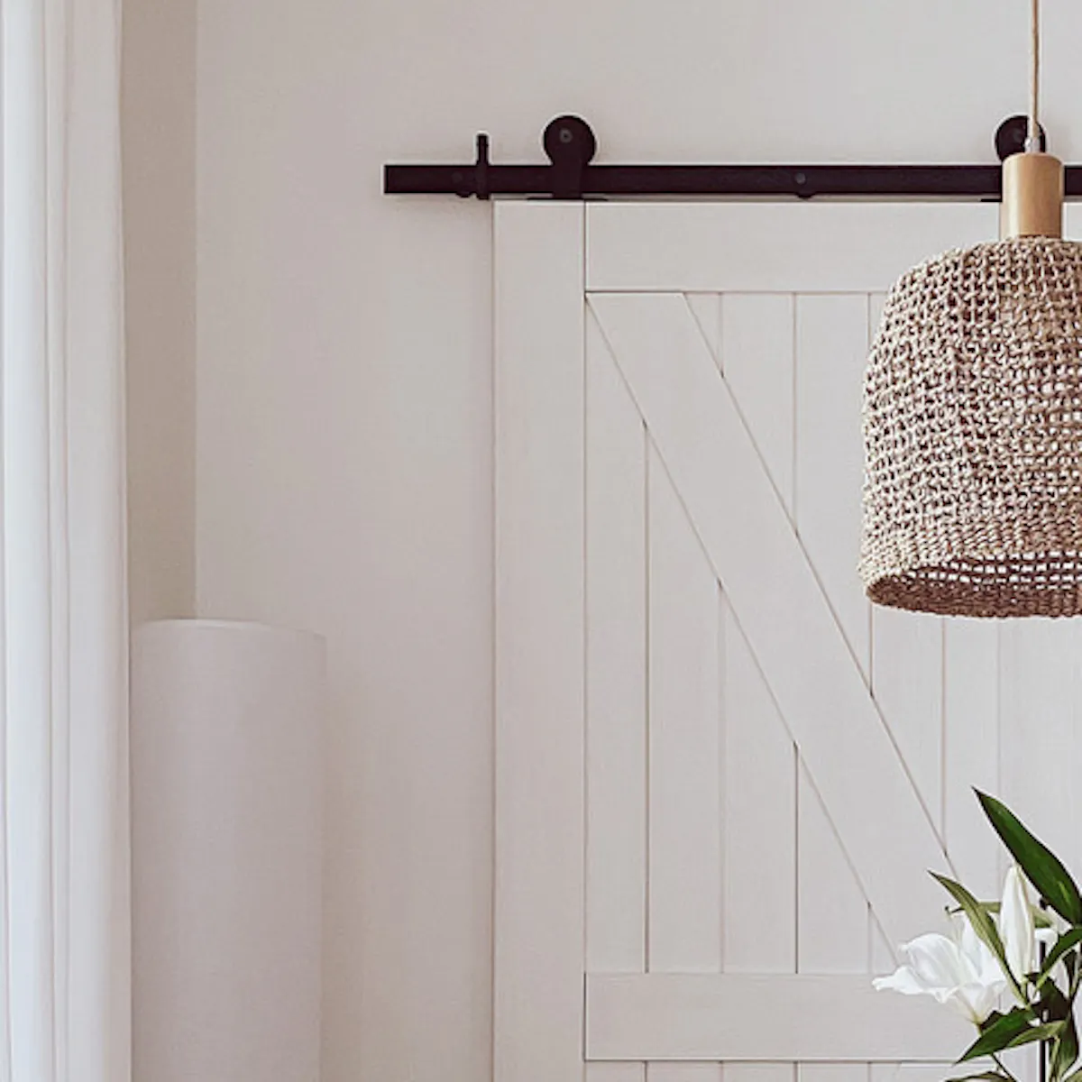 white chairs at the round table, boho style hanging lamp, white double sliding bedroom doors