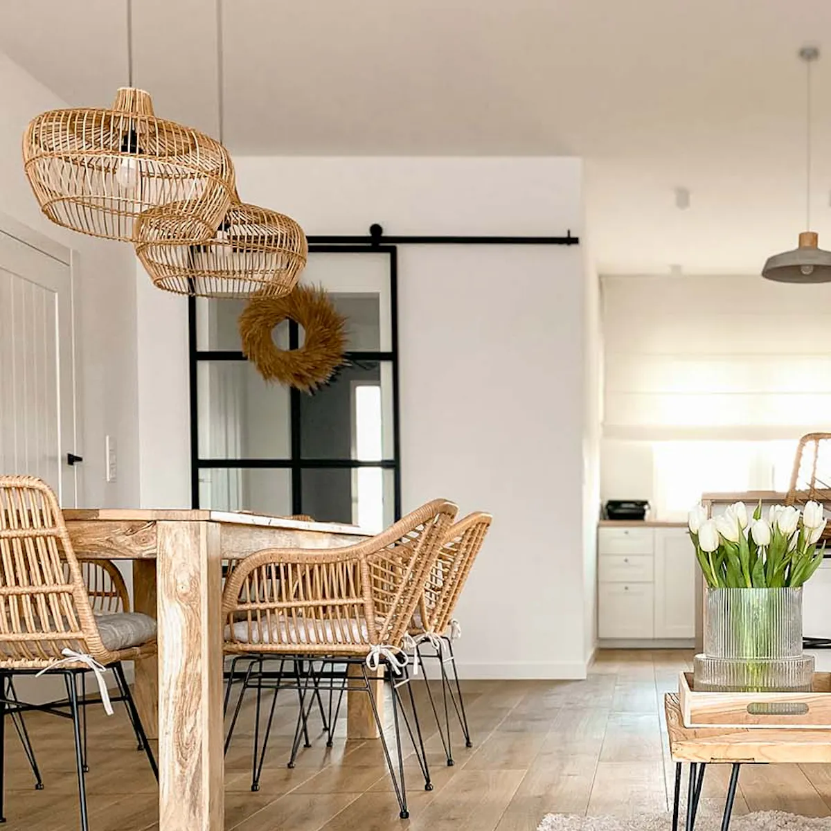 Living room with white walls and natural wood, rattan, and woven furniture
