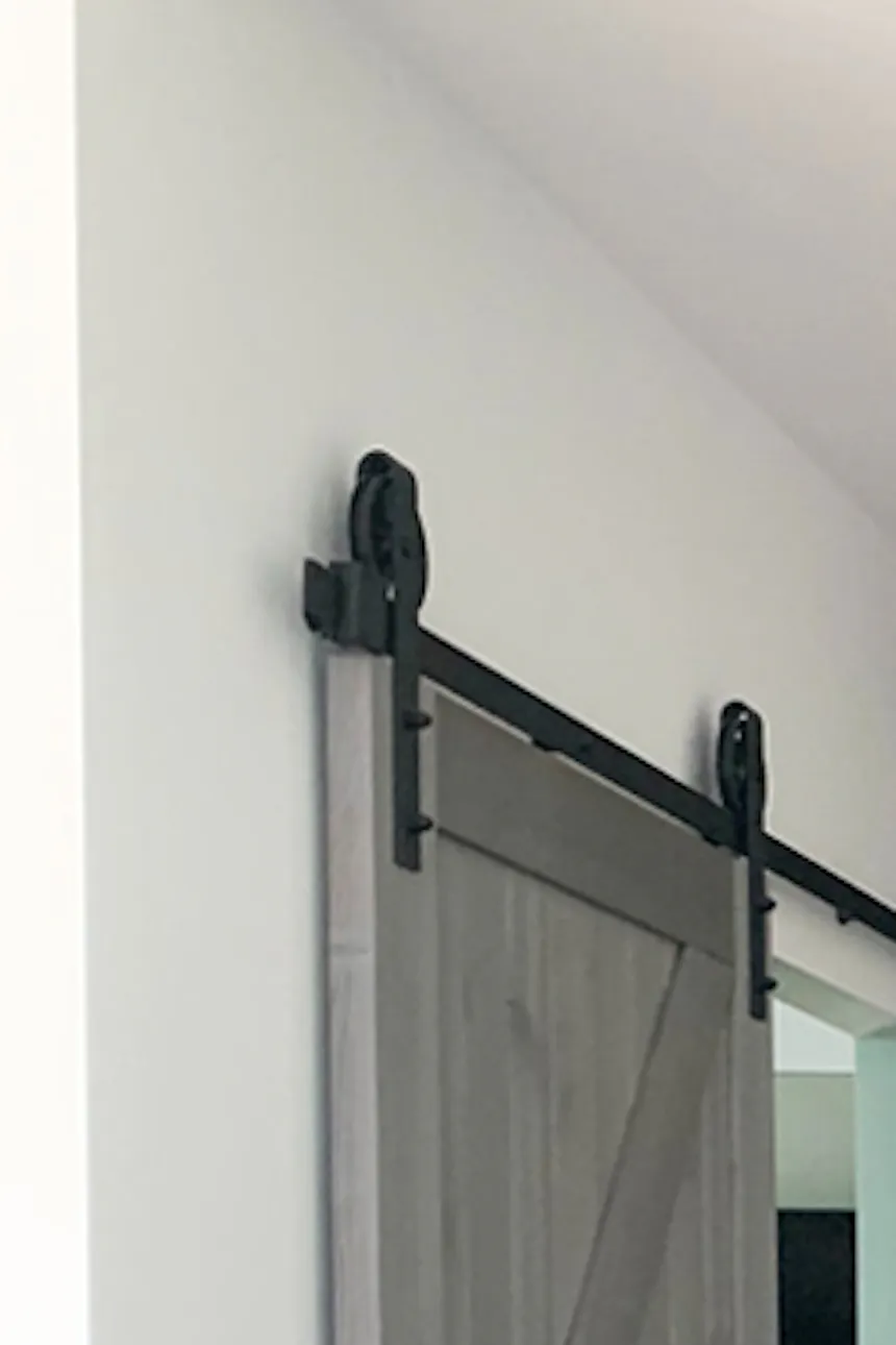 wooden sliding door, barn sliding doors grey wood, golden accessories in the interior, modern interior, open space, kitchen with dining room and living room, blue chairs for the dining room, sliding doors for the bedroom, clean colours in the interior