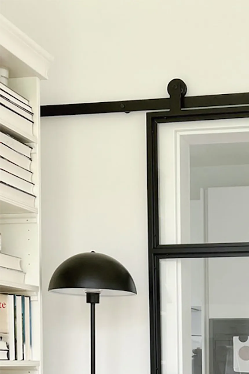 Glass sliding door in metal frame, industrial kitchen sliding door, black industrial floor lamp
