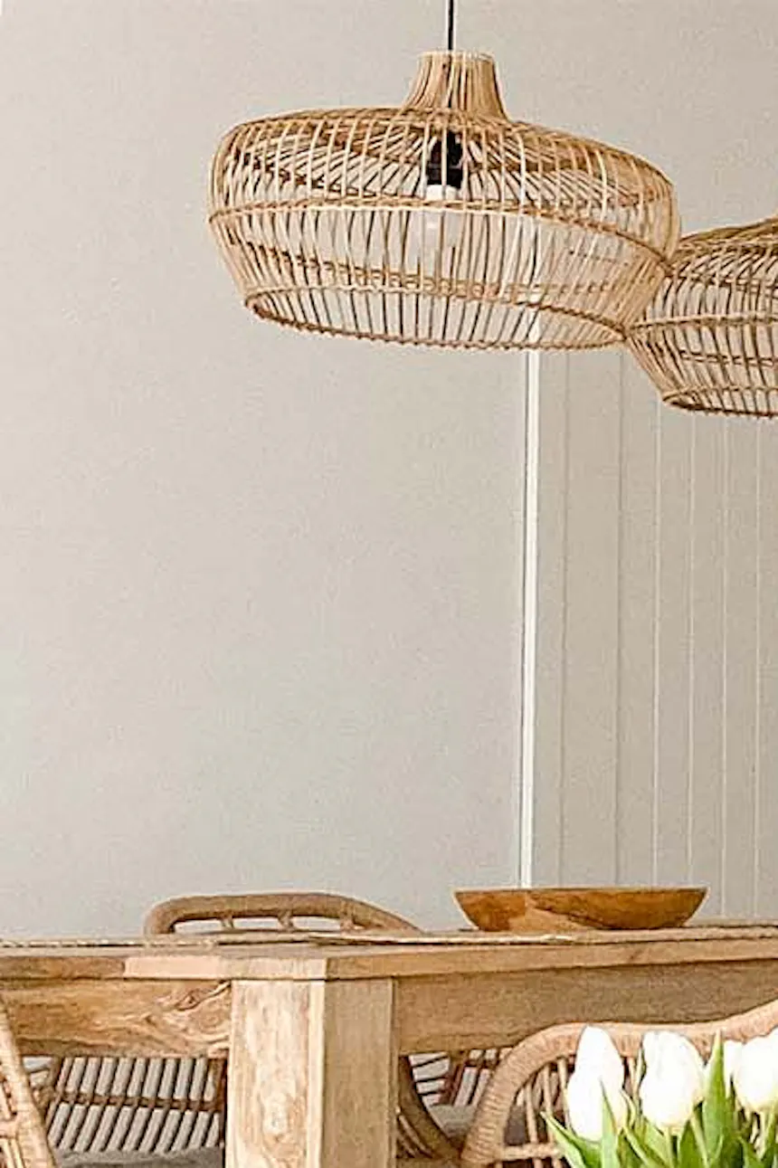 Square natural wood coffee table on metal legs in open-plan living and dining room