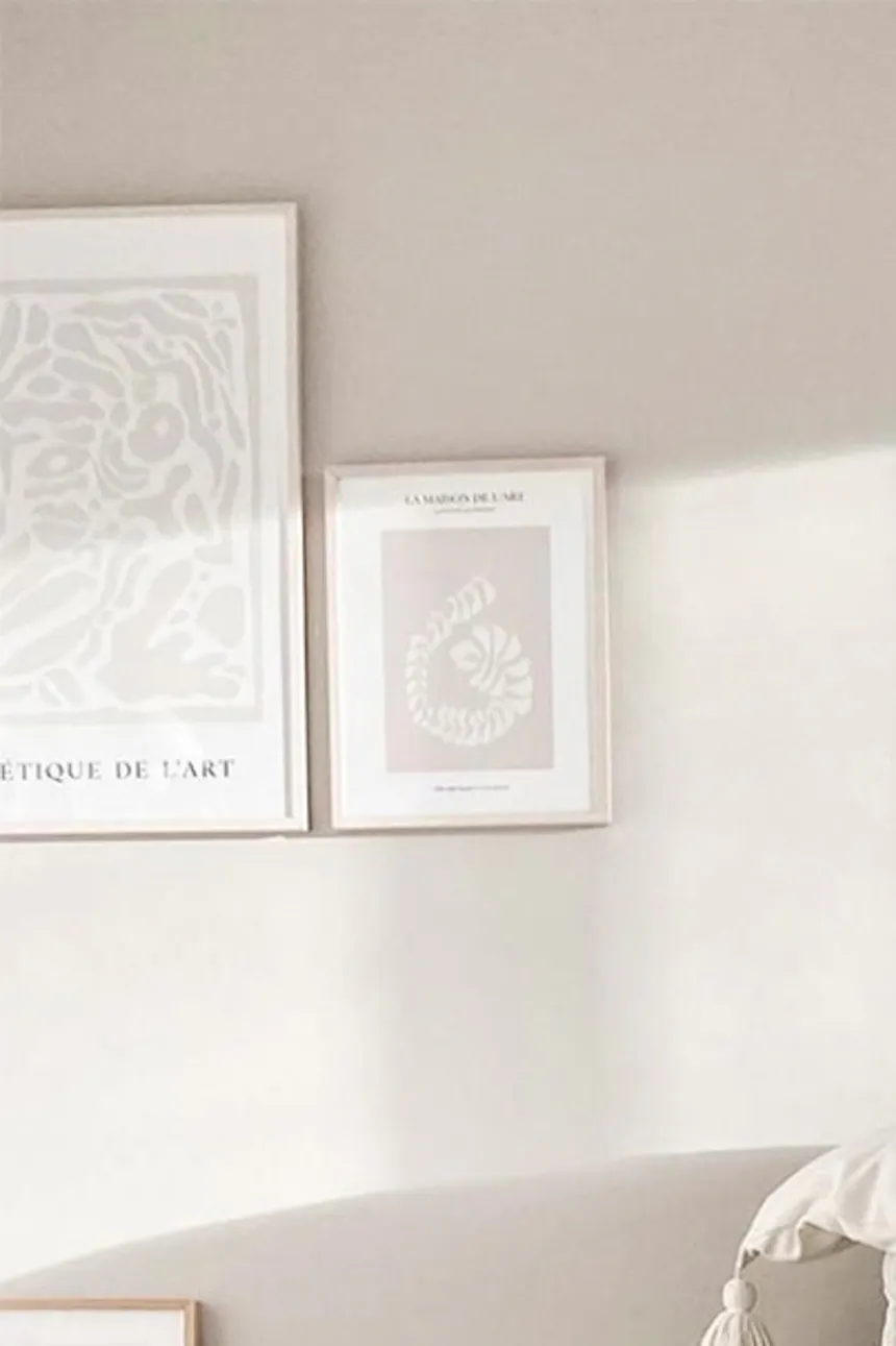 Light beige toned living room in Nordic style, coffee table decorations, beige sofa next to light wall