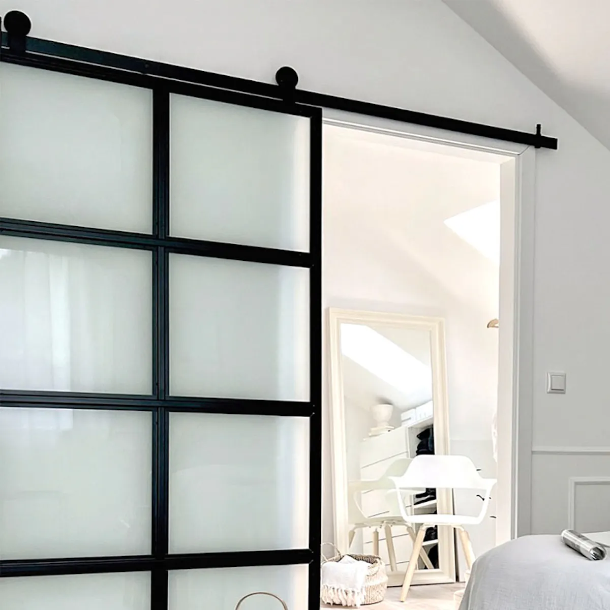 Attic bedroom with wardrobe and sliding doors, furnished in Nordic style