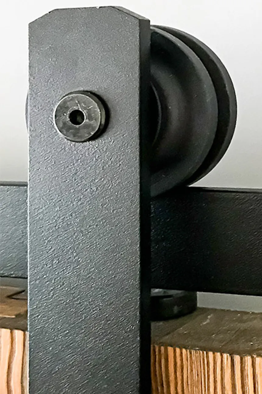 black sliding system mounted on wooden door