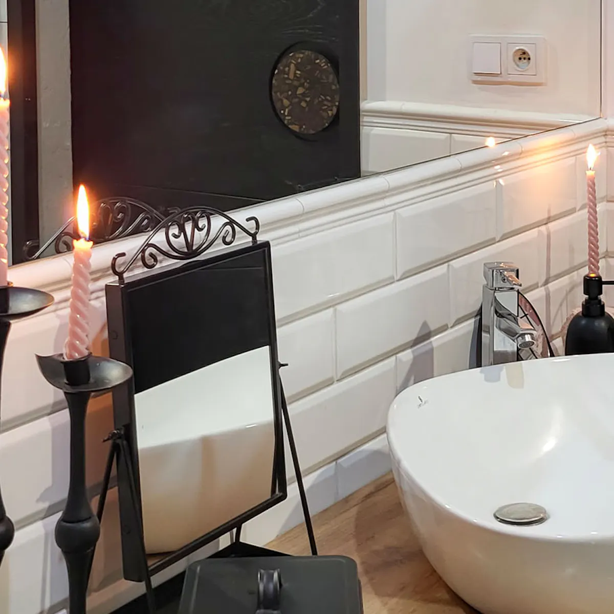 black accessories and a white sink on a wooden counter in the bathroom
