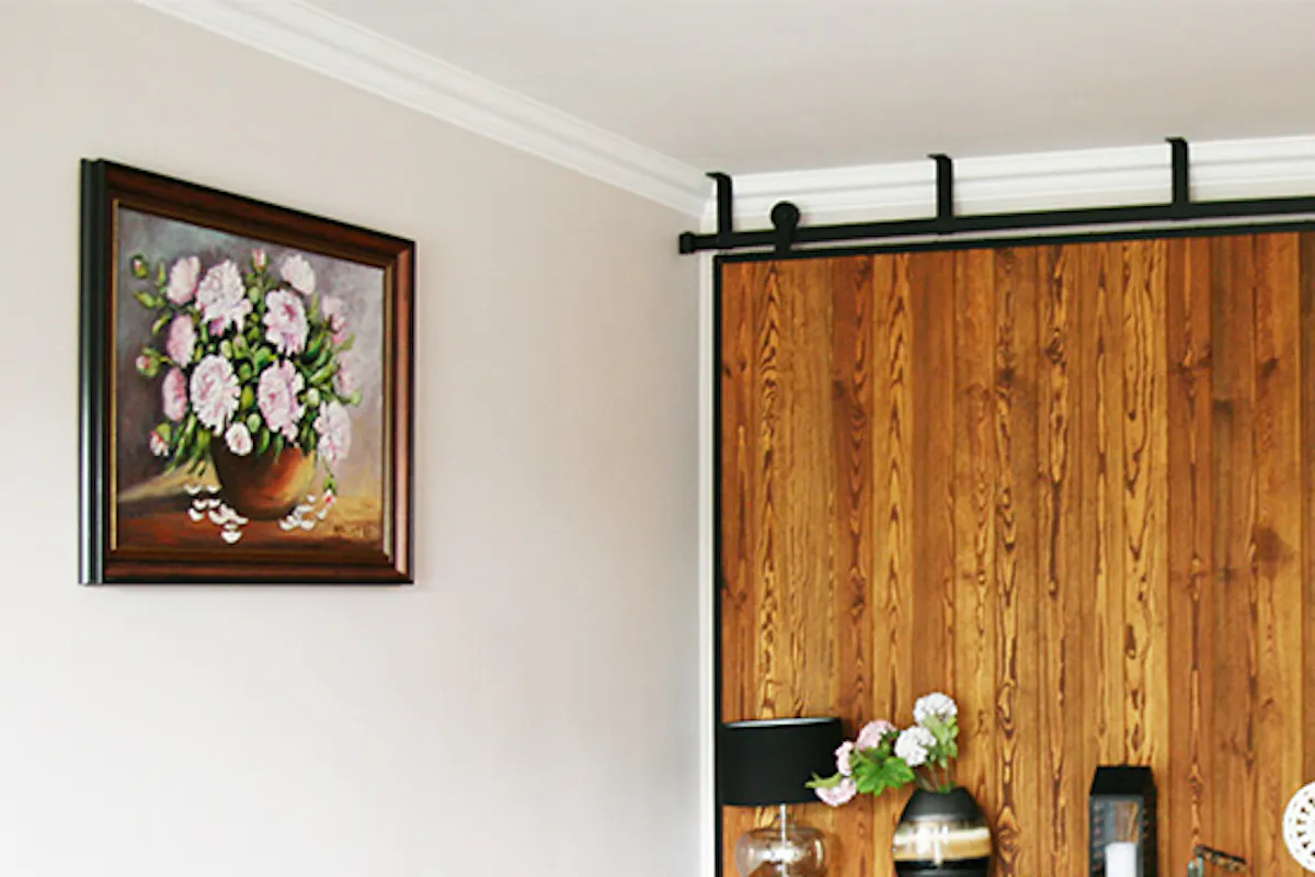 Large sliding door, sliding wall, wood sliding doors in metal frame, wood dresser, grey sofa, decorated dresser.