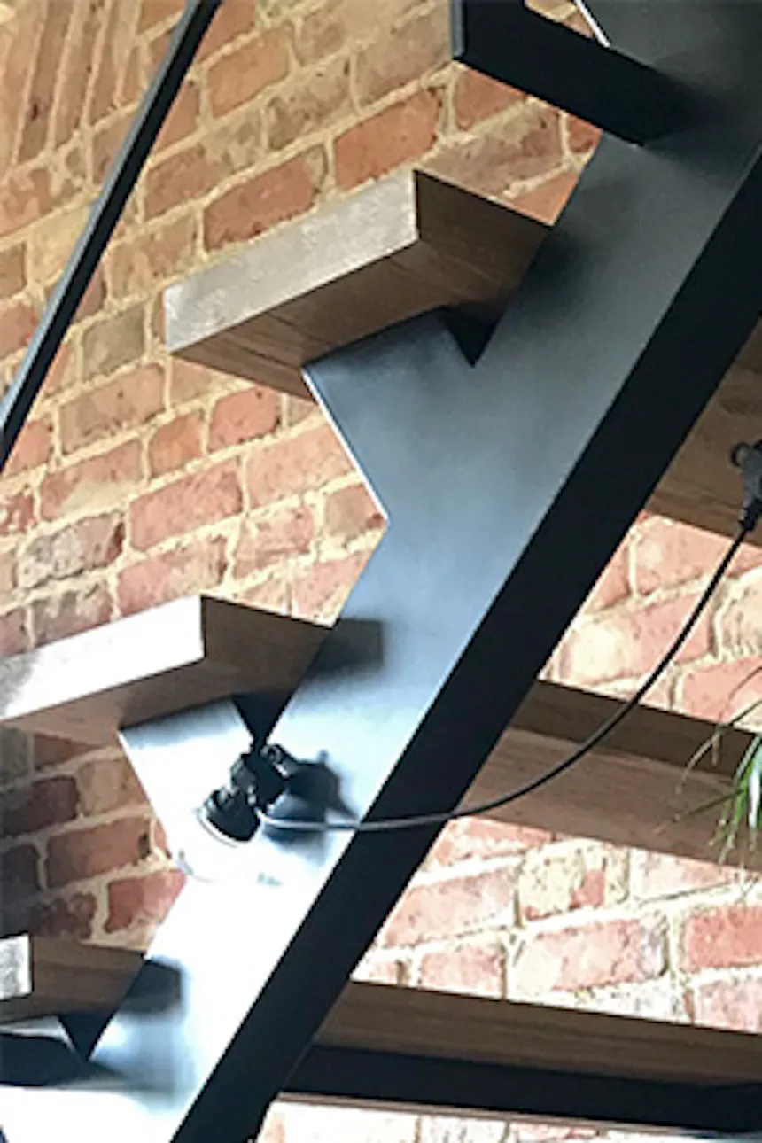 Retro chairs, metal loft-style stairs, loft interior, brick wall, loft style, vintage accessories, large plants in living room, metal lamps