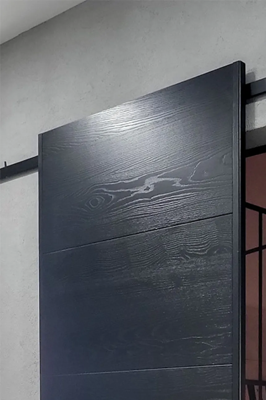 open black sliding door showing part of the bathroom