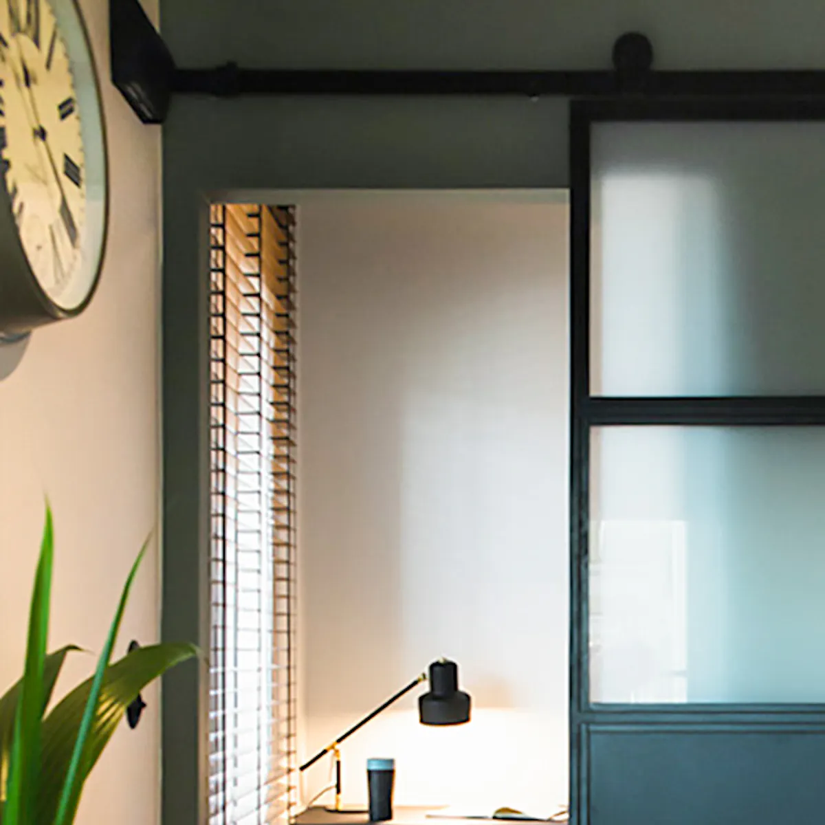 Industrial sliding doors, metal and glass doors, frosted glass doors, sliding doors to bedroom, small work corner, red chair
