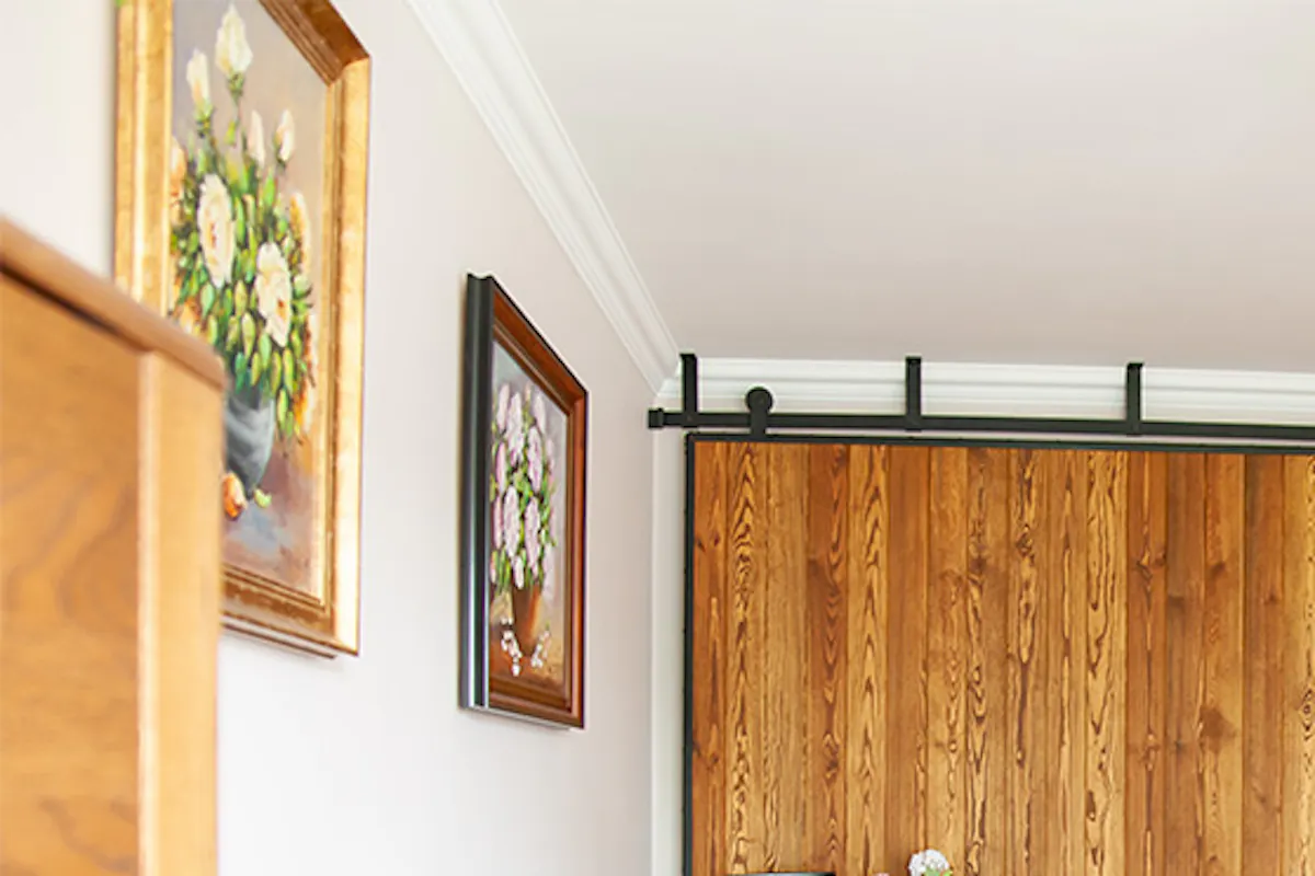 Large sliding door in metal frame, brick wall, sliding wall in living room, gray sofa