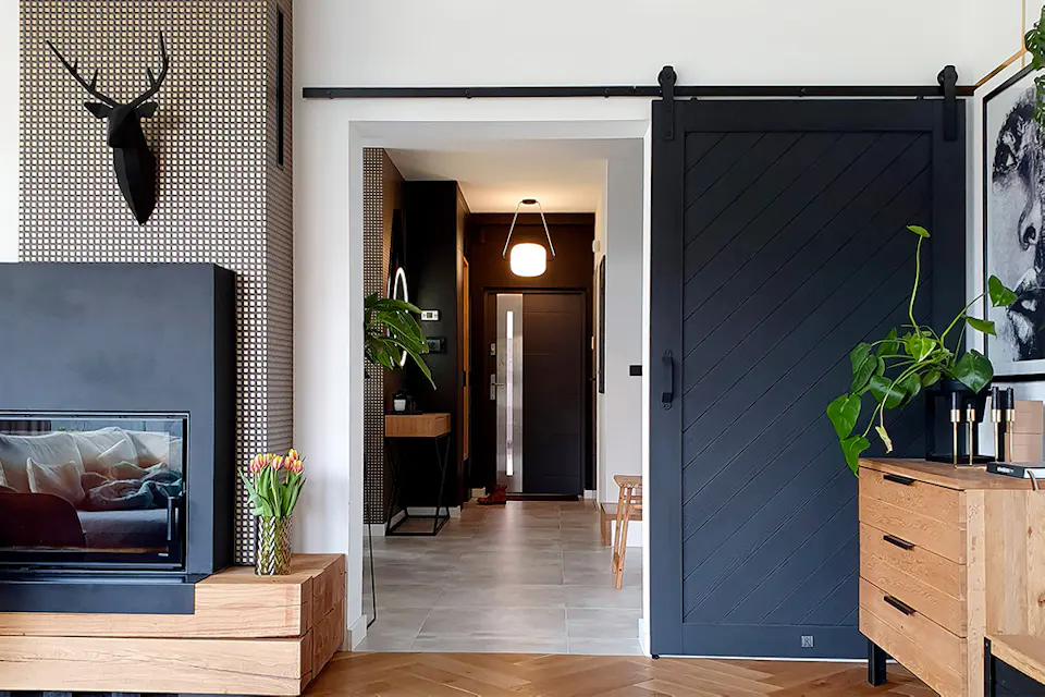 black sliding door between the living room and hallway in modern house