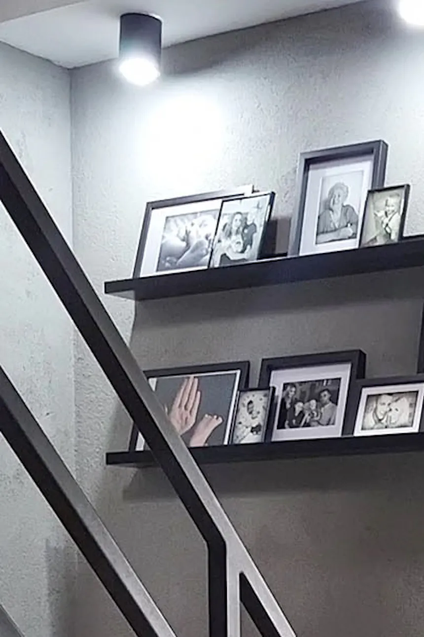 photo gallery in black frames on a grey concrete wall