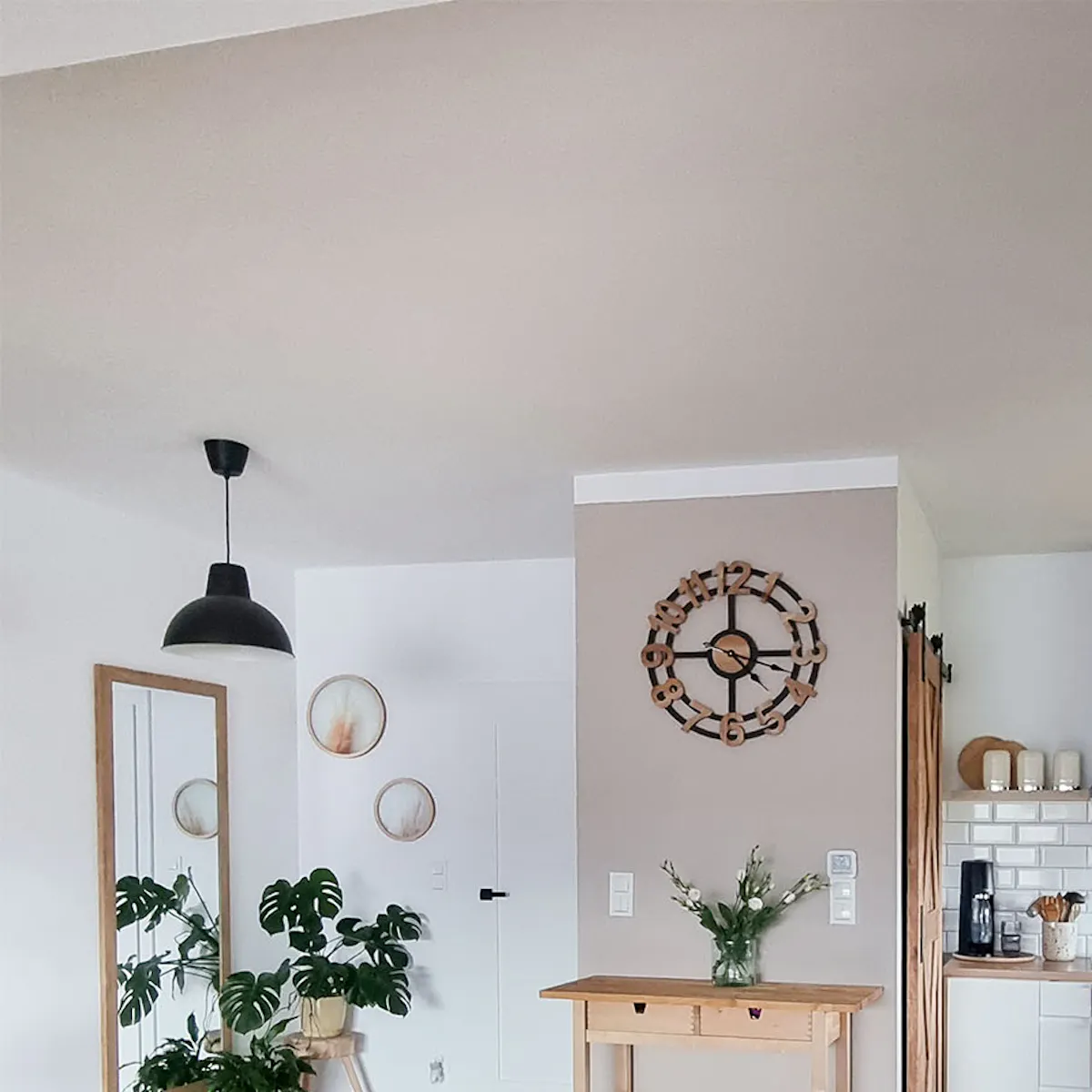white walls and a wooden floor in a Scandinavian kitchen with a pantry