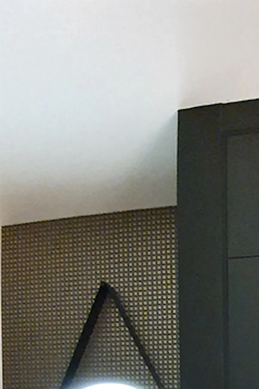 Black walls in foyer, niche for hangers, mirror with lighting, loft table