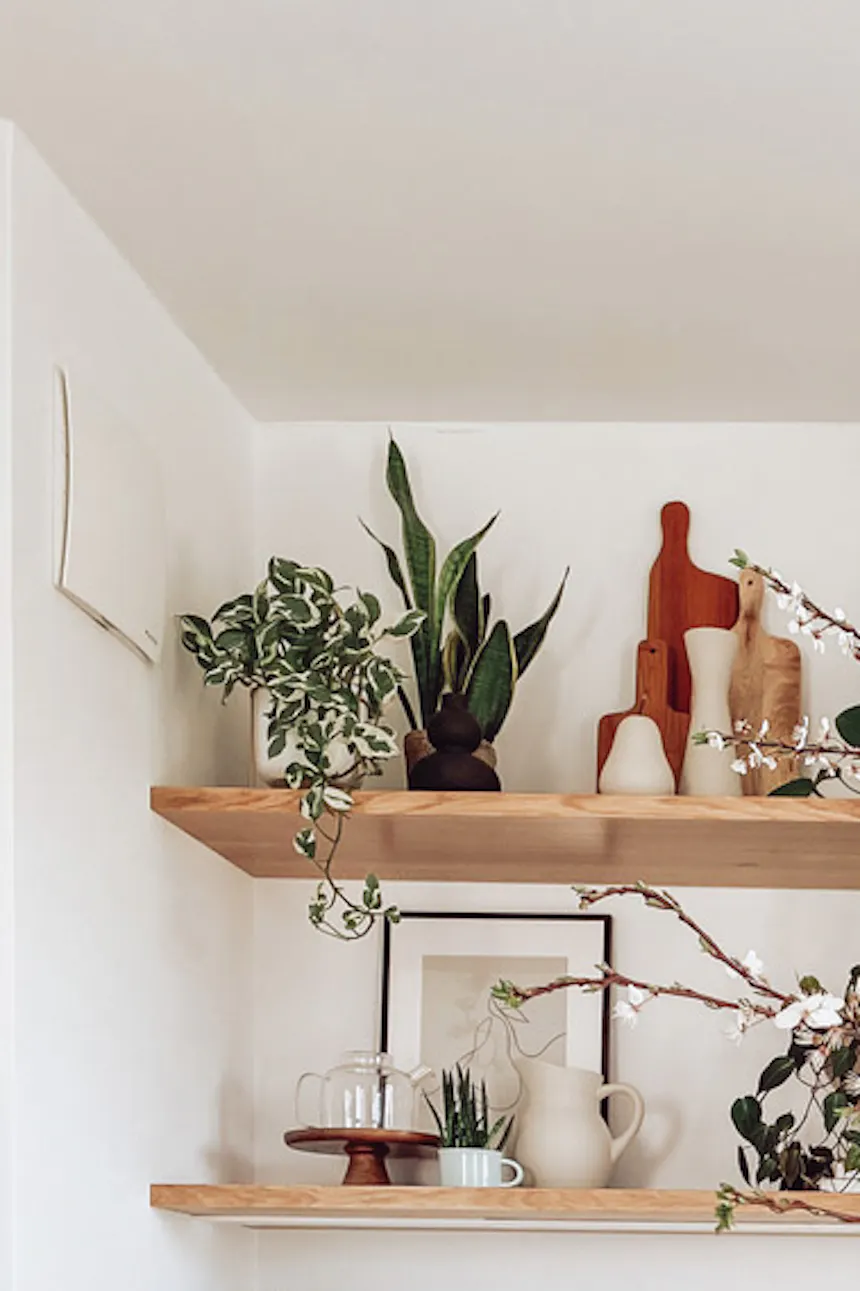 large white cabinets in the kitchen, white kitchen island, flowers and decorations in the white kitchen