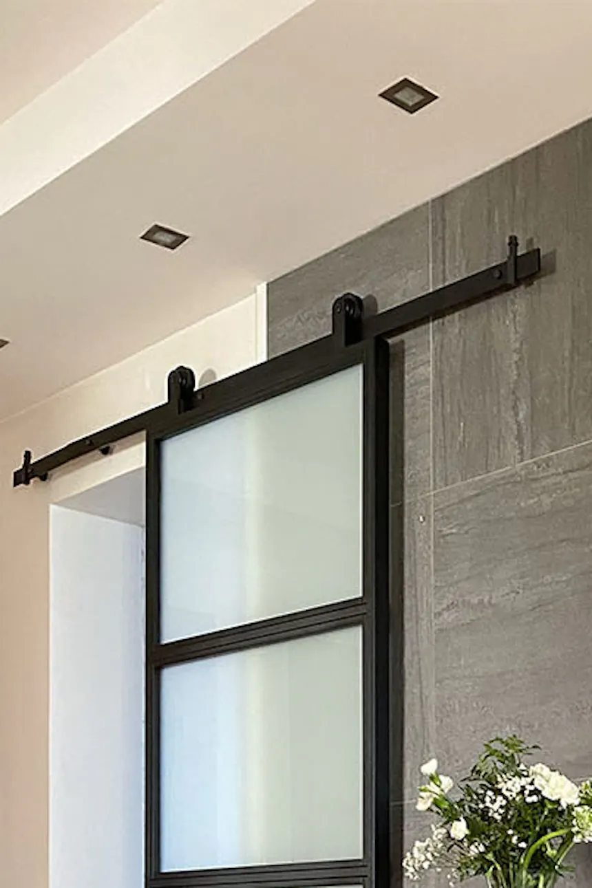 Loft glass doors, metal glass sliding door, black decorative console, décor on hallway console, console with mirror in hallway, graphite tiles on hallway wall