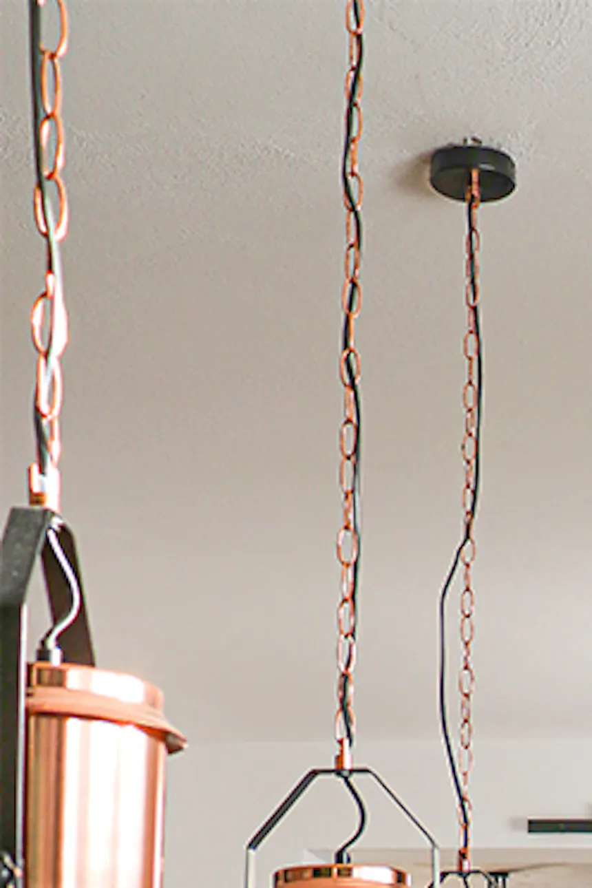Black metal wall clock, industrial style clock, loft décor, metal glass door, loft door, metal glass sliding door, black glass door, green dining chairs, open living room to dining room, industrial pendant lights for dining room, large wooden dining table
