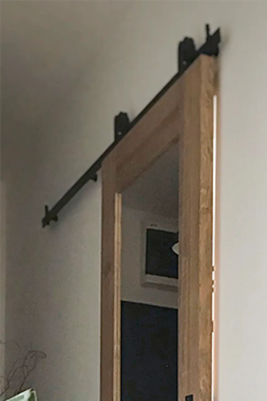 Sliding door to office, wooden door with mirror, sliding door with mirror, large metal floor lamp, leather armchair on metal base, vintage chair, parquet flooring in living room, mirror in hallway
