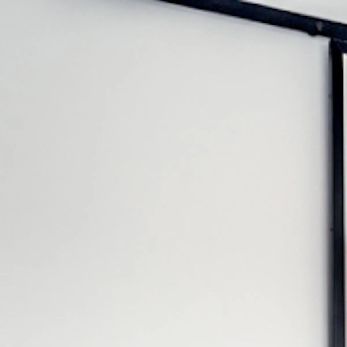 Sliding door with mirror in black metal frame closes off niche in bedroom