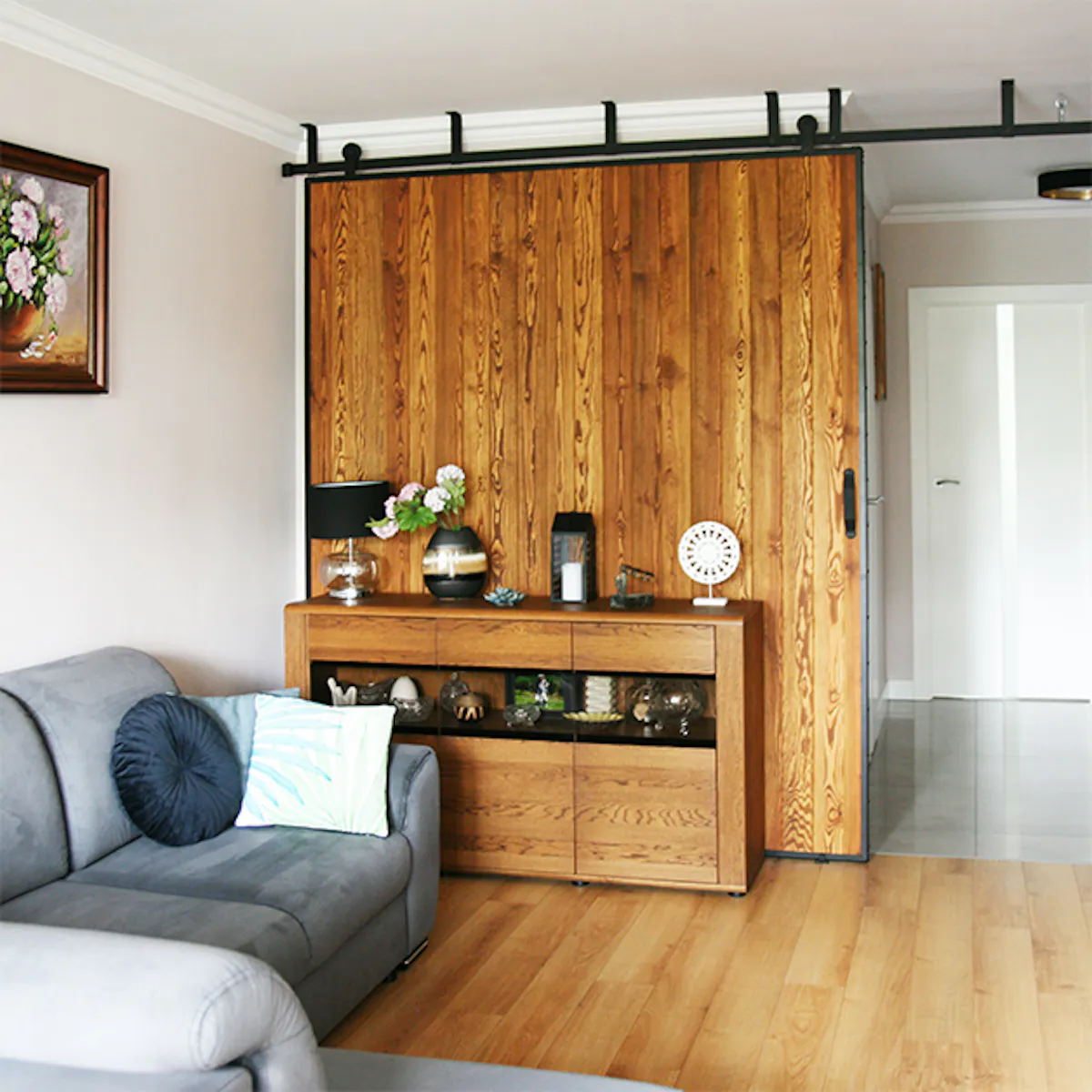 Large sliding door, sliding wall, wood sliding doors in metal frame, wood dresser, grey sofa, decorated dresser.