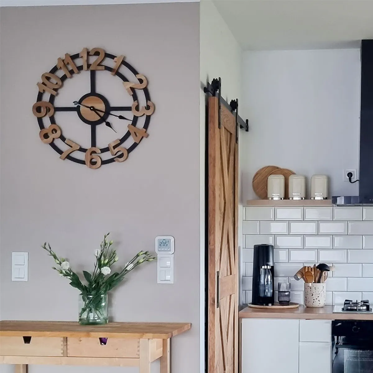 white kitchen cabinets with a wooden top by the wooden door to the pantry