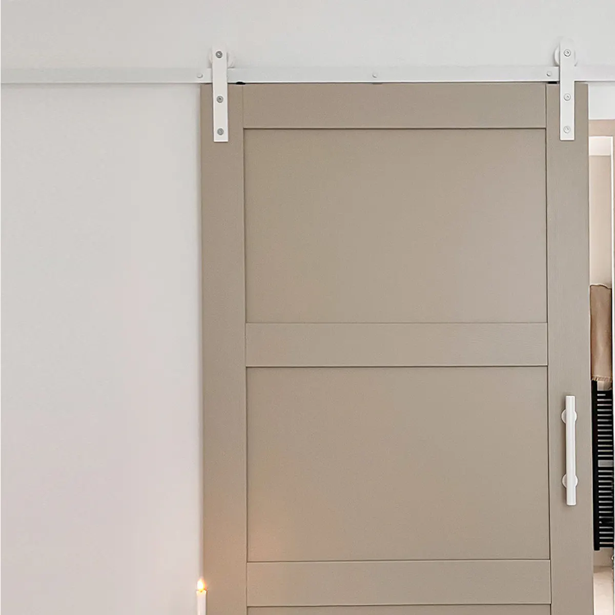 Pebble gray door with white sliding system at bathroom entrance