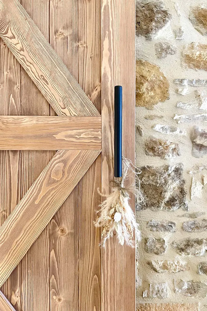 poignée noire sur porte coulissante en bois
