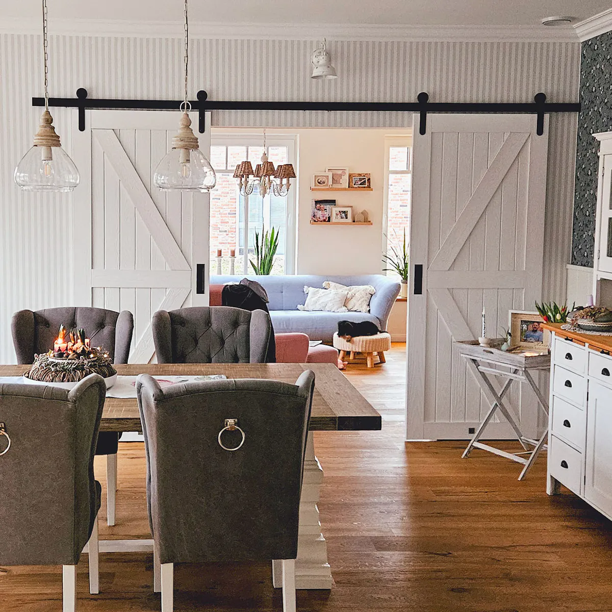 White double sliding doors between dining room and living room in rustic modern style