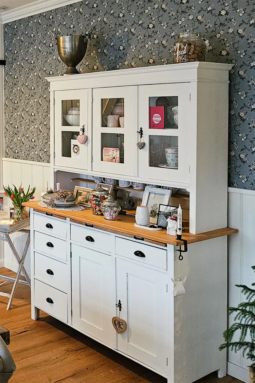 White glass sideboard displaying dishes and decorations