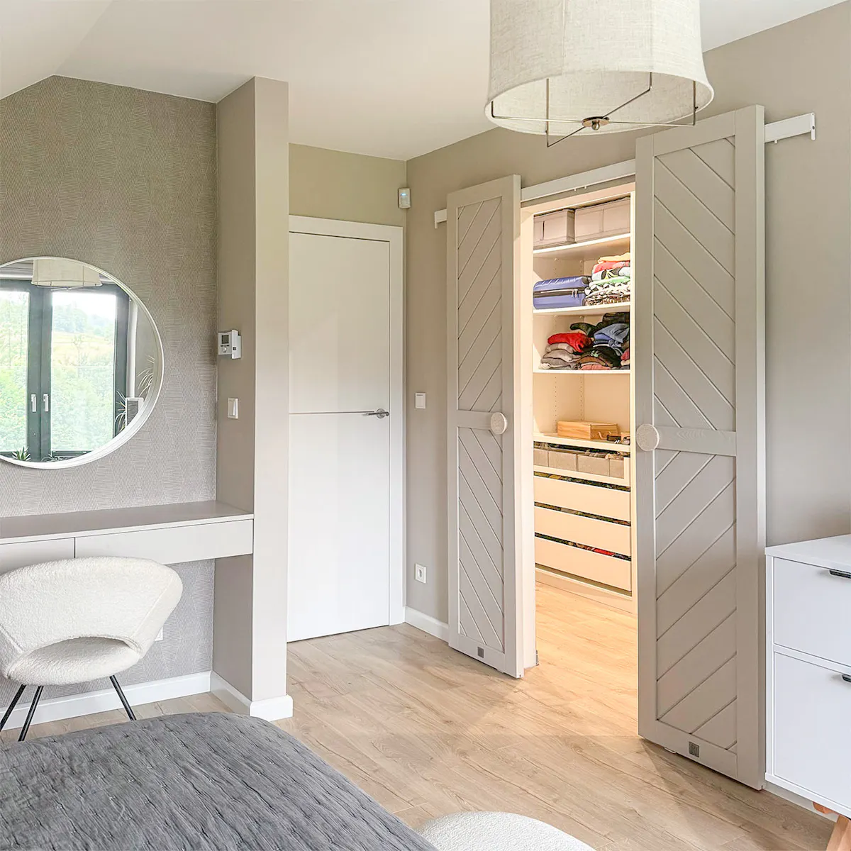Open double sliding doors revealing part of walk-in closet