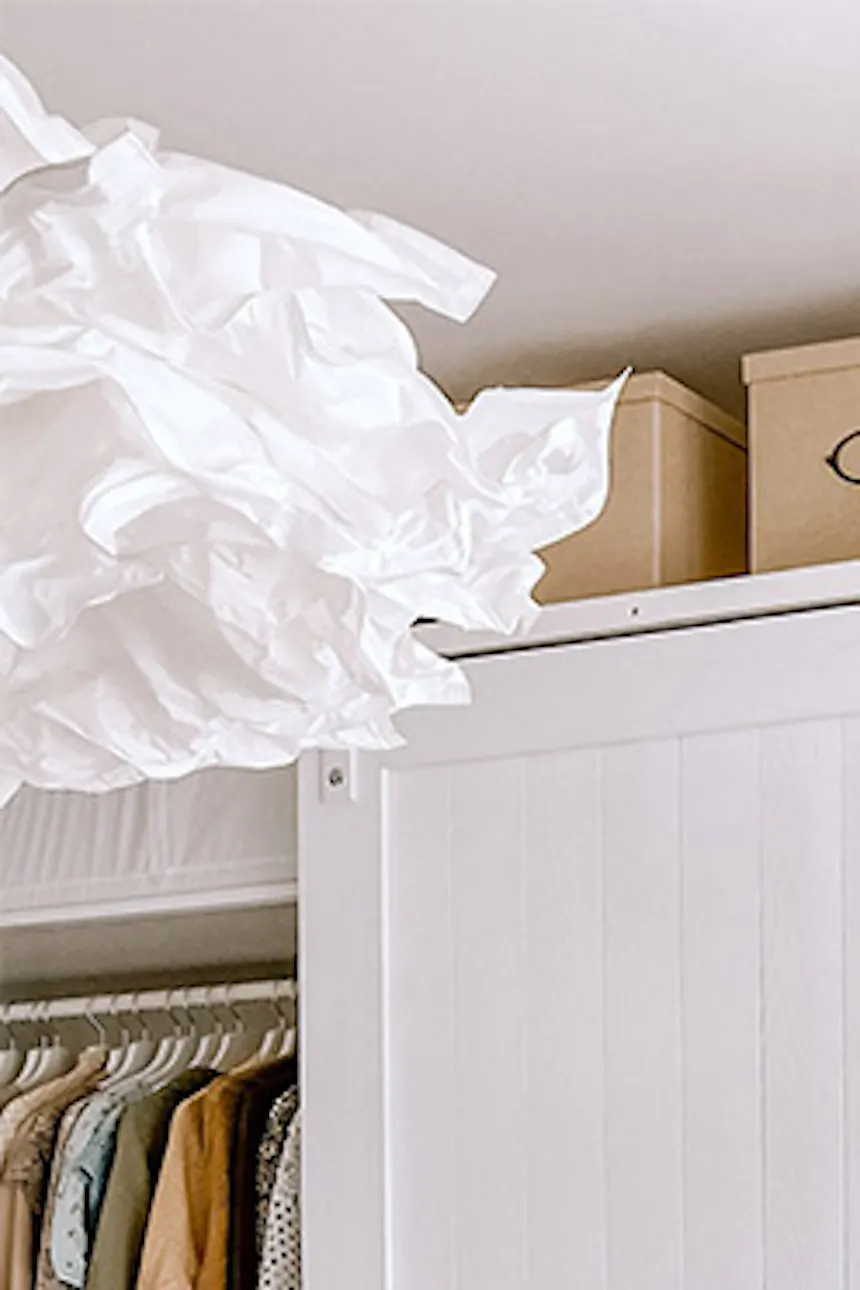 large white wardrobe, sliding wardrobe doors, white shelves for shoes, large and bright walk-in closet