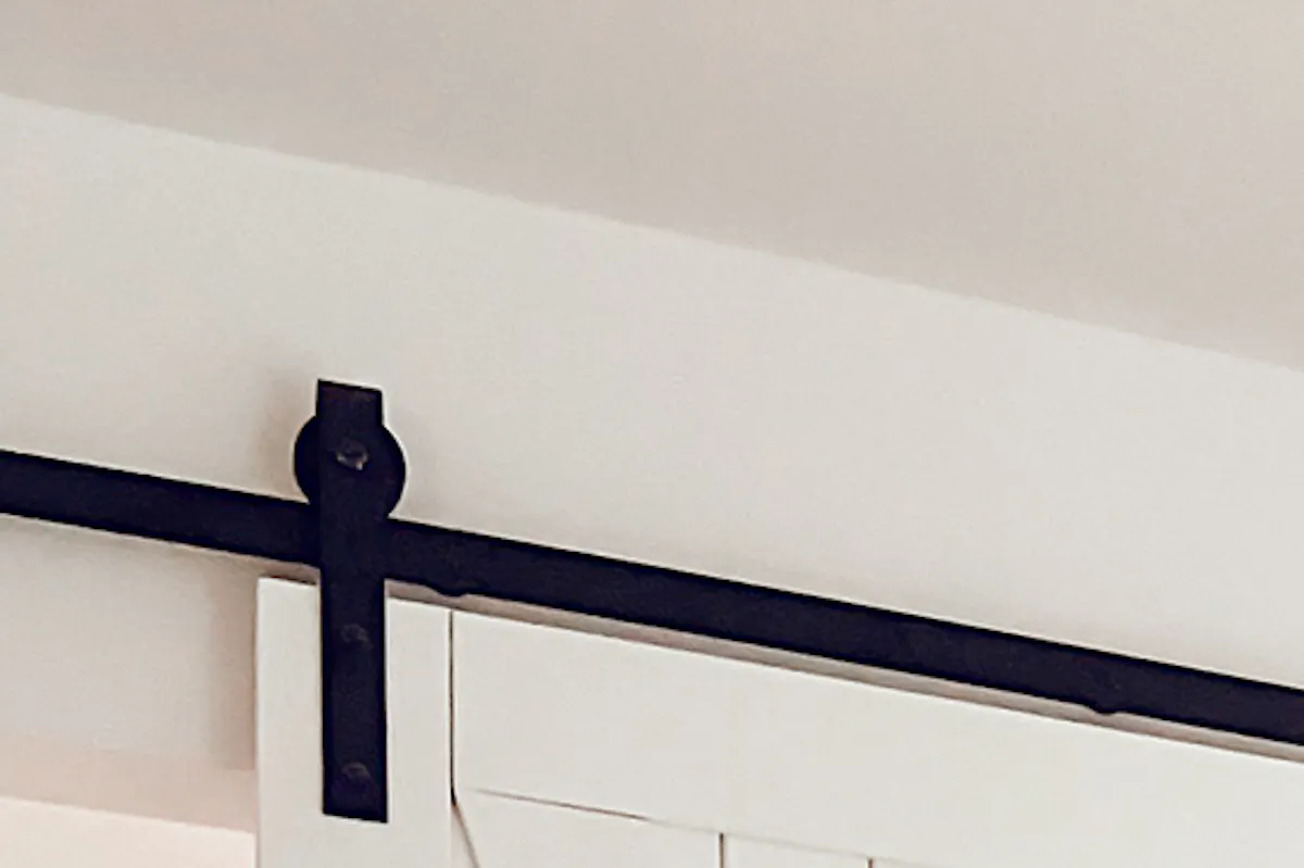 white wooden door with a black sliding system