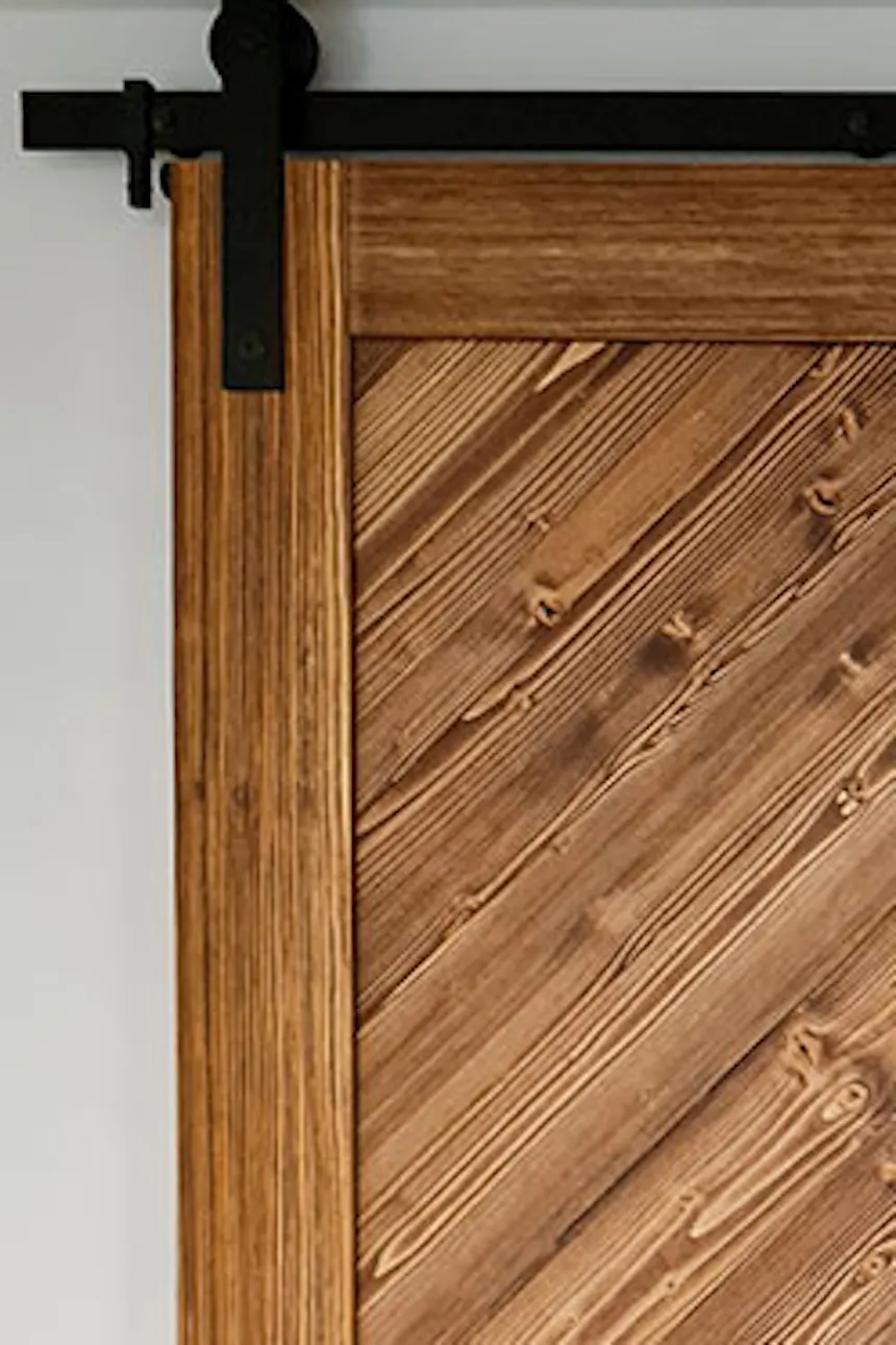 solid wood sliding doors, black sliding system, white walls in a Scandinavian interior