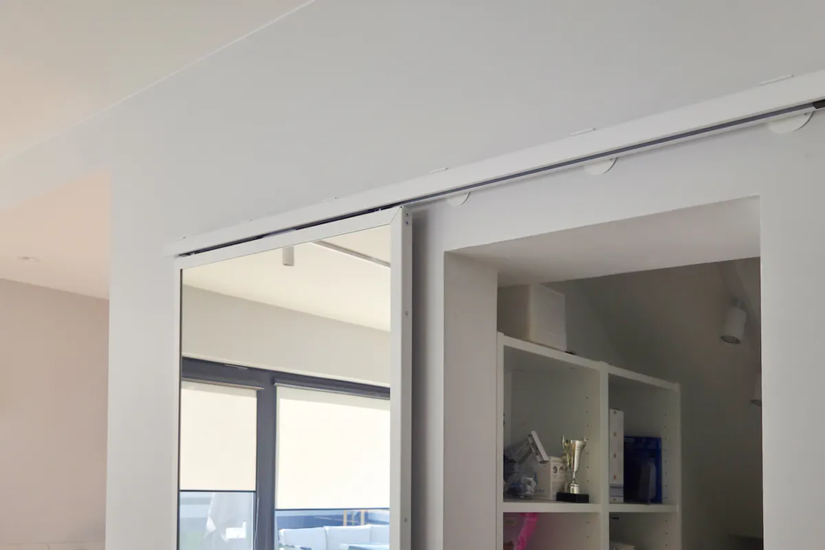TOP WALL sliding door system with mirror, mounted above the door opening on the guide rail