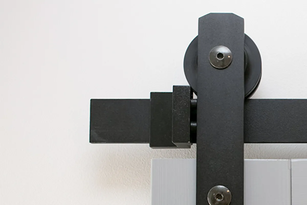 Black sliding system for grey wood doors.