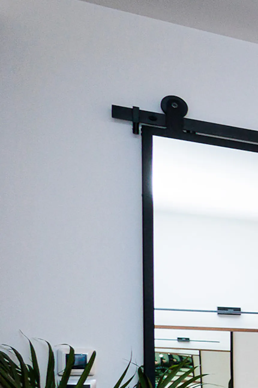 Large sliding mirror with black metal frame