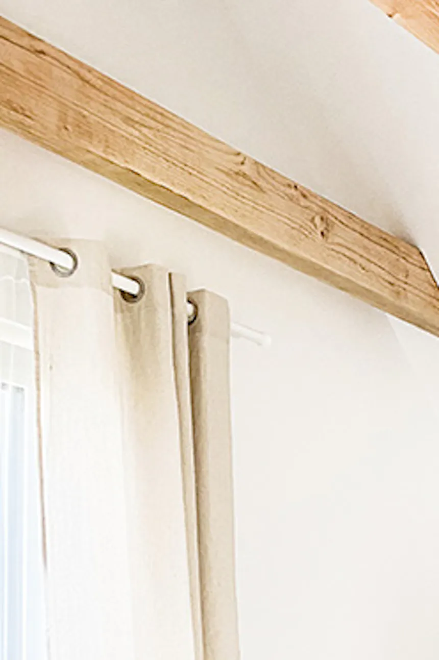 white bedroom, rustic bedroom, boho style bedroom, bamboo hanging lamp, wooden beams in bedroom